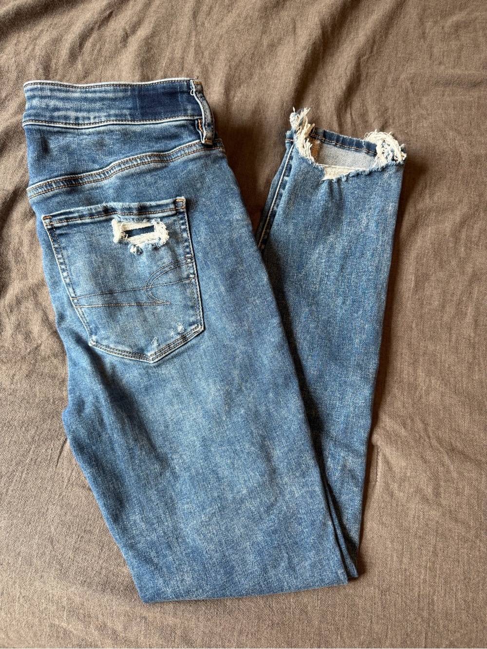 American Eagle Outfitters Light Blue Skinny Jeans with Distressed Hem